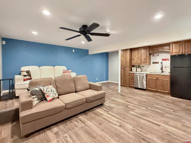 a living room with furniture and kitchen view