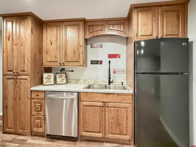 a kitchen with stainless steel appliances granite countertop a refrigerator and a sink