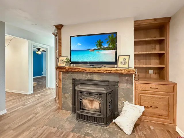 a living room with a fireplace and a flat screen tv