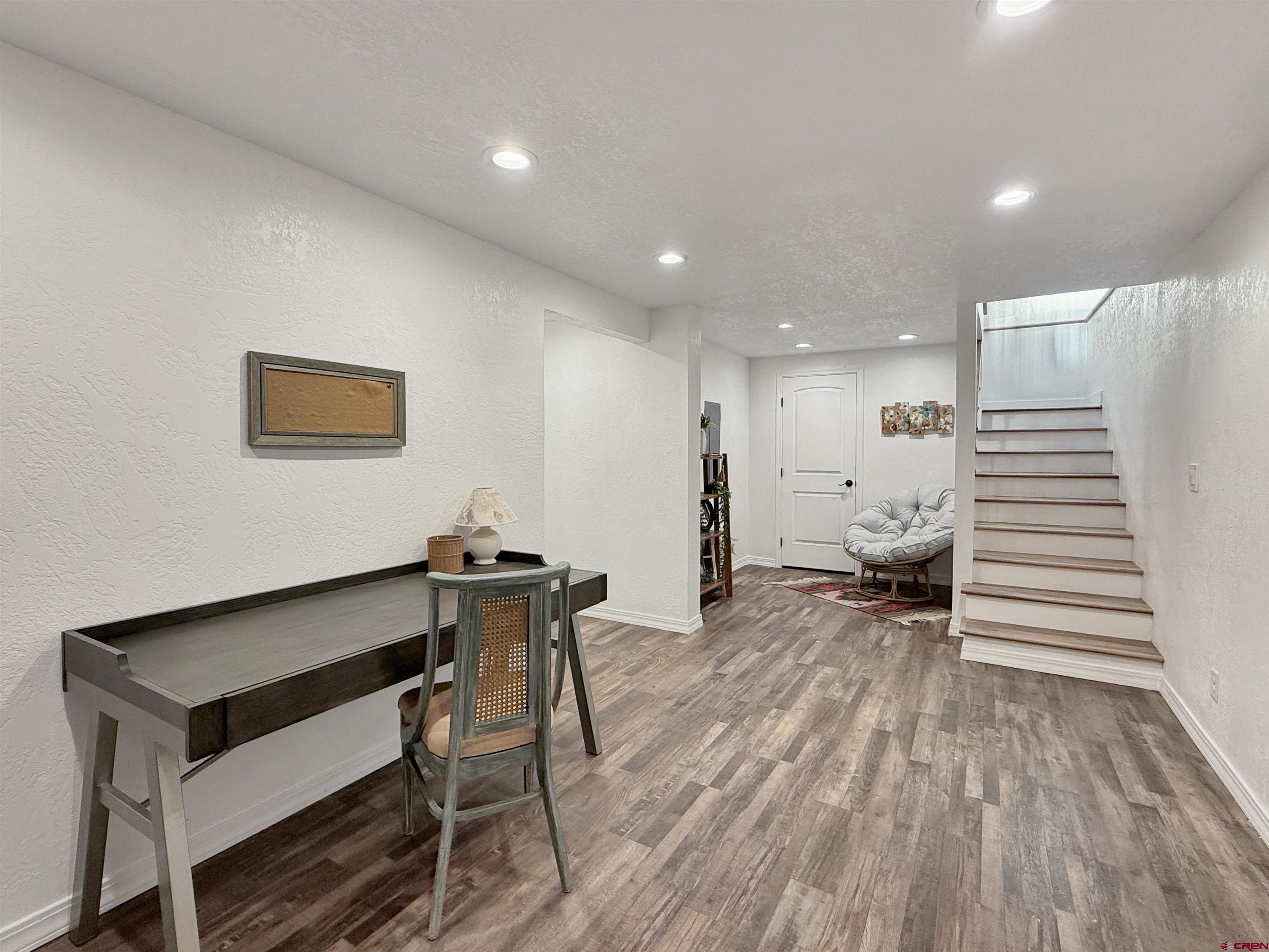 27425 Rd P.7 Dolores, CO 81323 - Photo 30 of 45 a view of a hallway with wooden floor and furniture