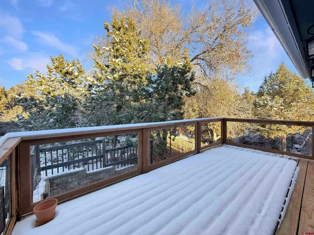 a view of balcony with wooden floor and fence