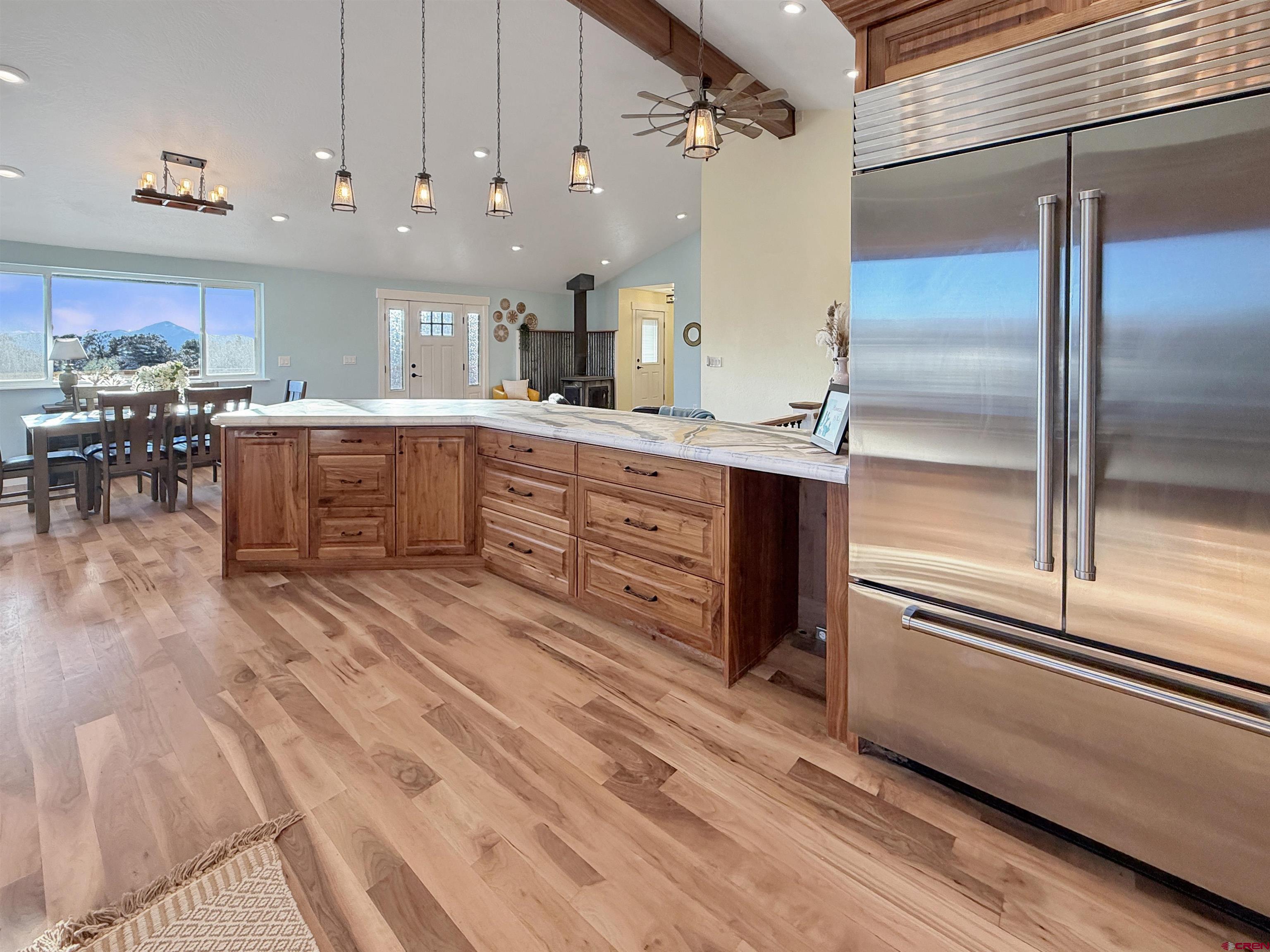 27425 Rd P.7 Dolores, CO 81323 - Photo 8 of 45 a kitchen with stainless steel appliances kitchen island granite countertop a refrigerator a stove and a sink with granite countertops