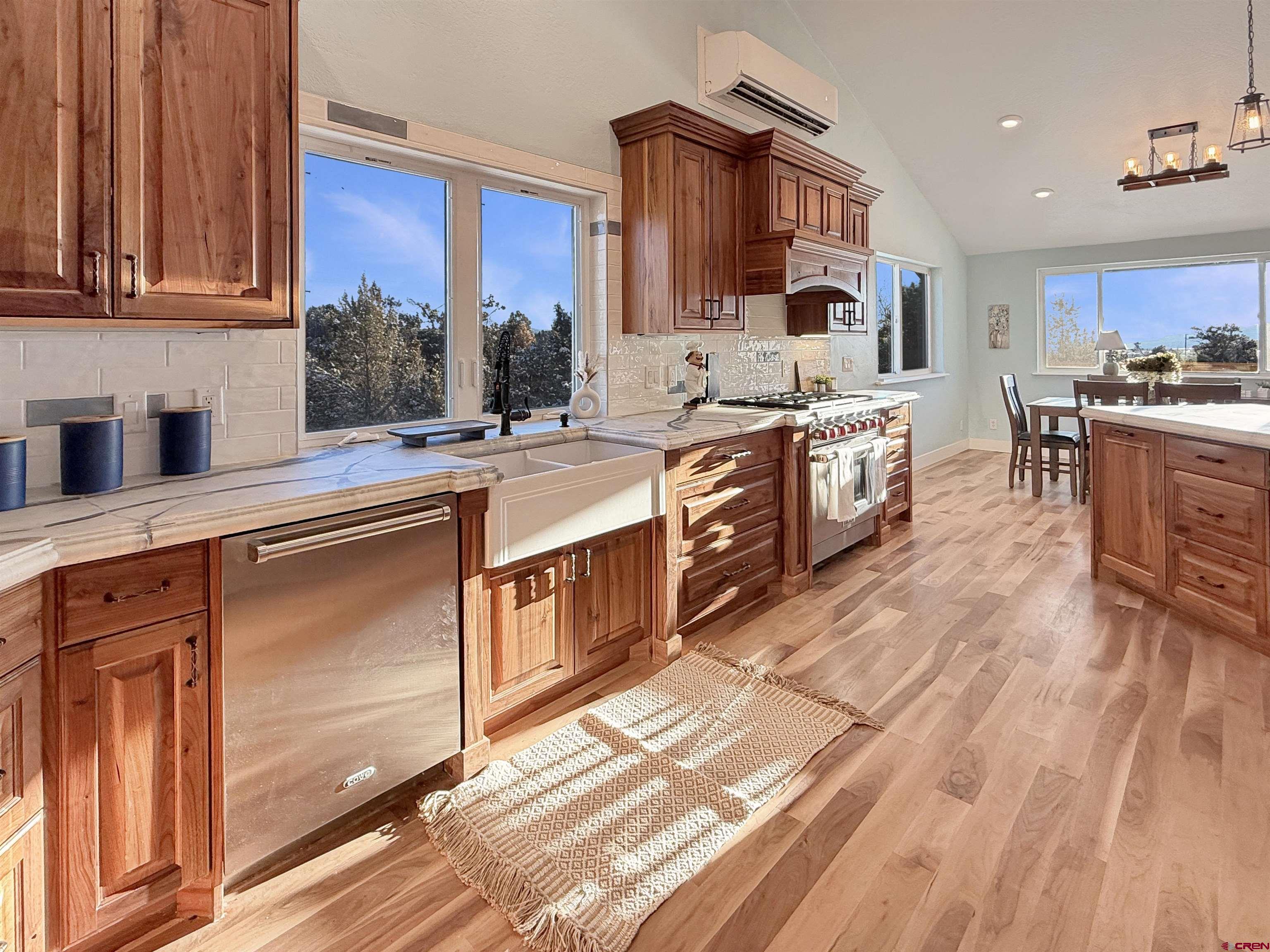 27425 Rd P.7 Dolores, CO 81323 - Photo 9 of 45 a large kitchen with stainless steel appliances granite countertop a stove a sink dishwasher and cabinets with wooden floor