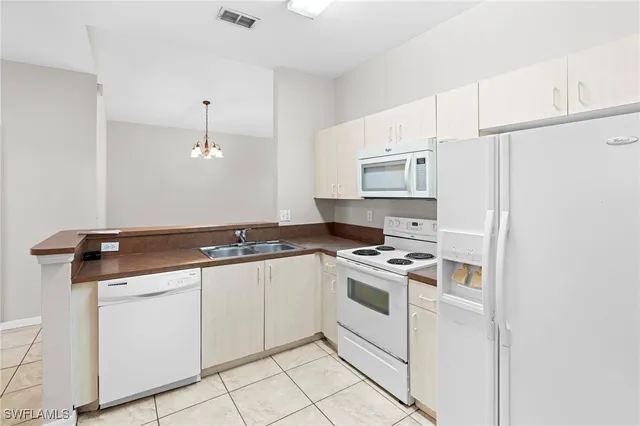 a kitchen with a stove sink and cabinets