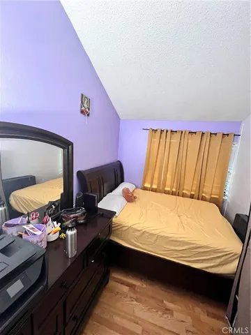 a bedroom with a bed and dresser