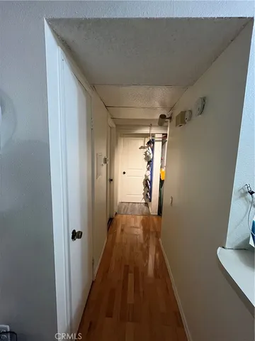 a view of hallway with wooden floor