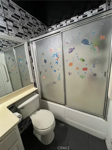 a white toilet sitting next to a small bathroom