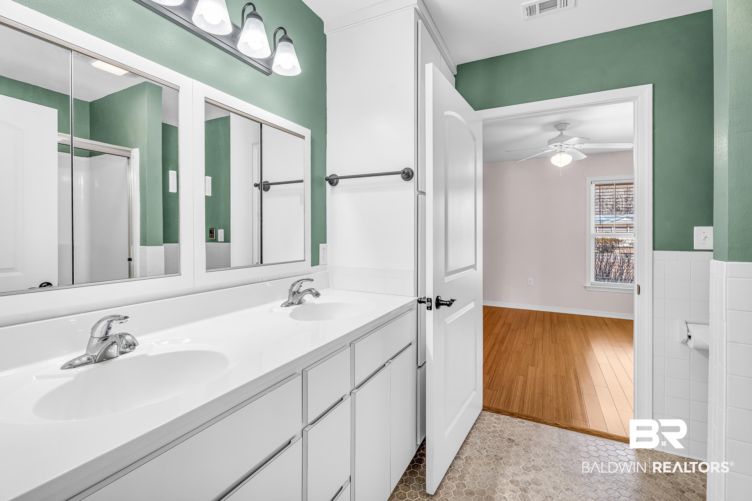 22095 8th Street Silverhill, AL 36576 - Photo 32 of 42 Full bathroom featuring double vanity, a ceiling fan, and a shower with shower door