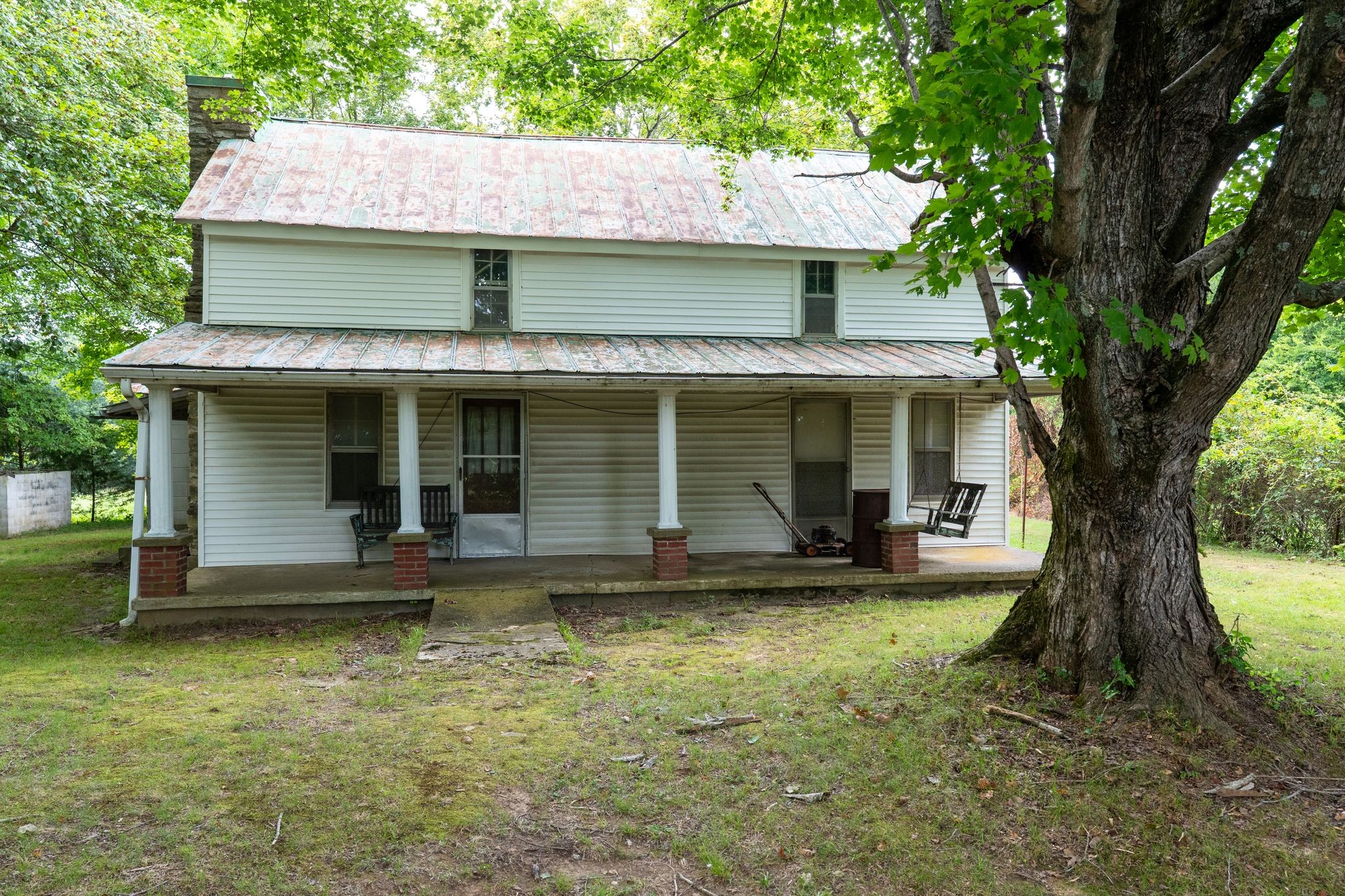 a view of a house with backyard porch and sitting area
