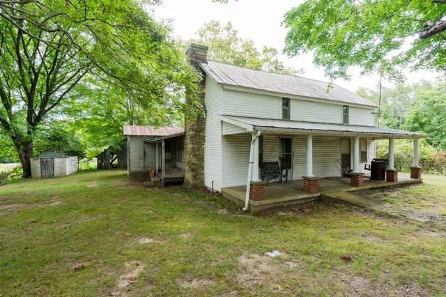 a view of an house with backyard space and balcony