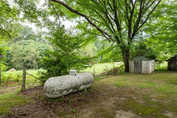 a backyard of a house with table and chairs