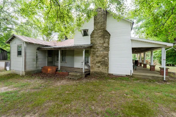 a backyard of a house with table and chairs