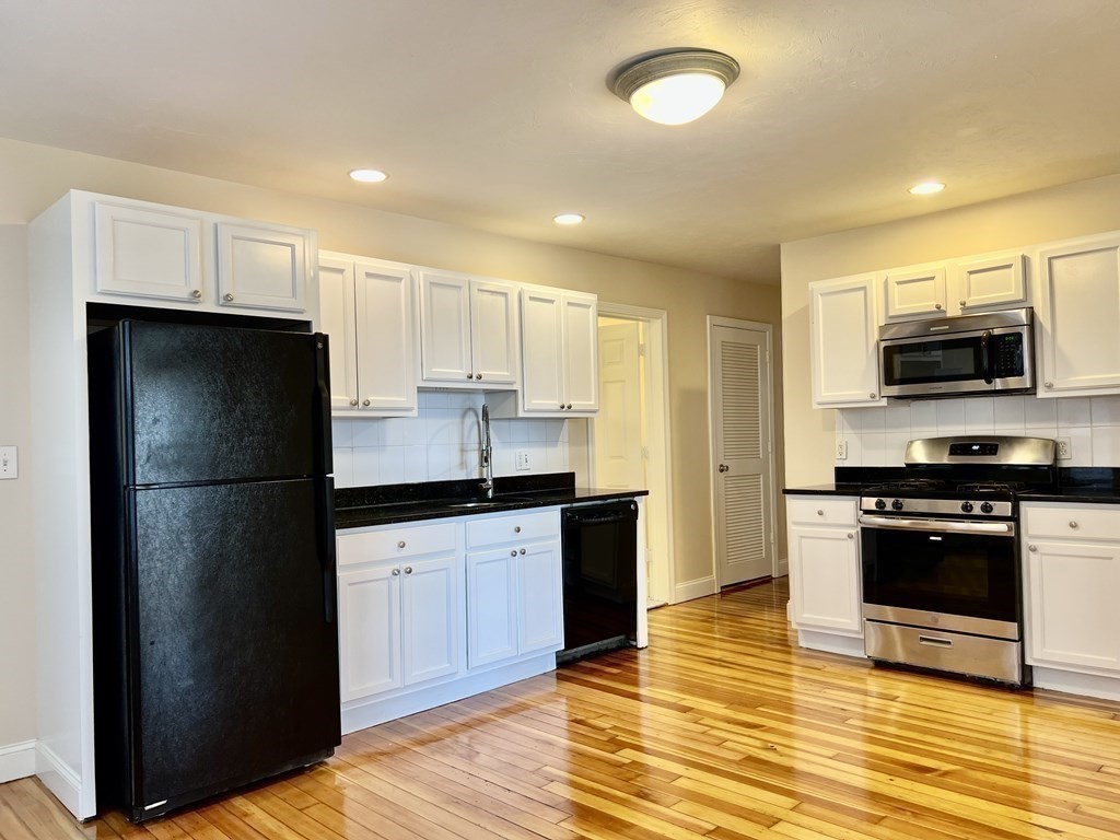 41 Harbor Street, Unit 3 Salem, MA 01970 - Photo 11 of 20 a kitchen with a refrigerator and a stove top oven