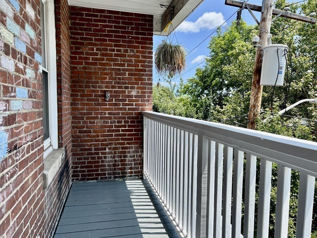 41 Harbor Street, Unit 3 Salem, MA 01970 - Photo 16 of 20 a view of a balcony with a floor to ceiling window stairs and wooden floor