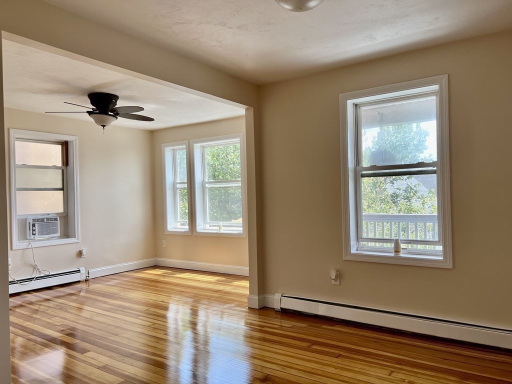 41 Harbor Street, Unit 3 Salem, MA 01970 - Photo 2 of 20 a view of an empty room with wooden floor and a window