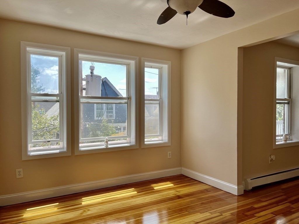 41 Harbor Street, Unit 3 Salem, MA 01970 - Photo 3 of 20 a view of an empty room with wooden floor and a window