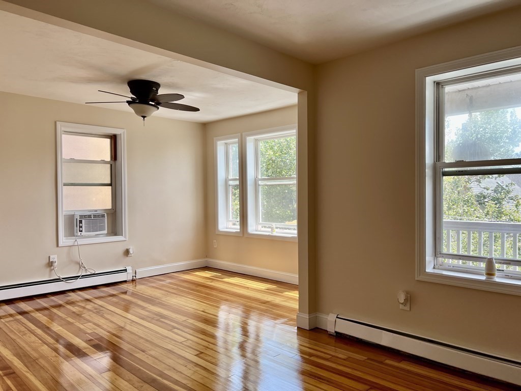 41 Harbor Street, Unit 3 Salem, MA 01970 - Photo 6 of 20 a view of an empty room with a window and wooden floor