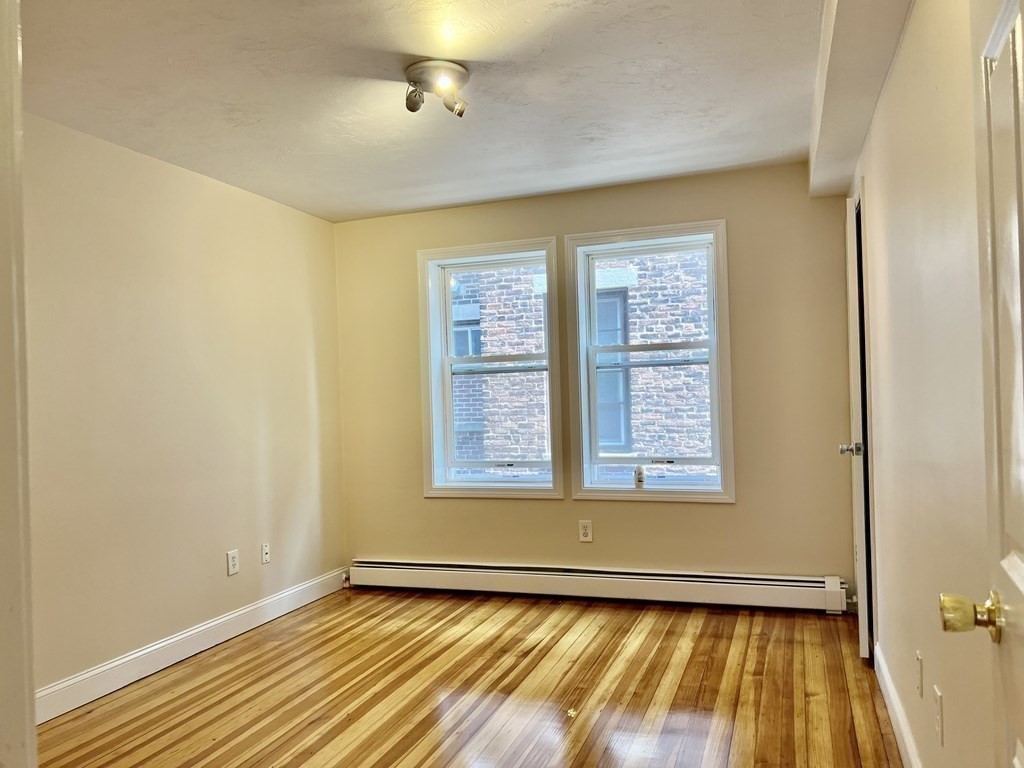 41 Harbor Street, Unit 3 Salem, MA 01970 - Photo 7 of 20 a view of an empty room with glass door and wooden floor