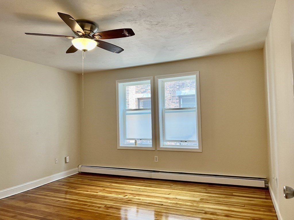 41 Harbor Street, Unit 3 Salem, MA 01970 - Photo 9 of 20 a view of an empty room with wooden floor and a window