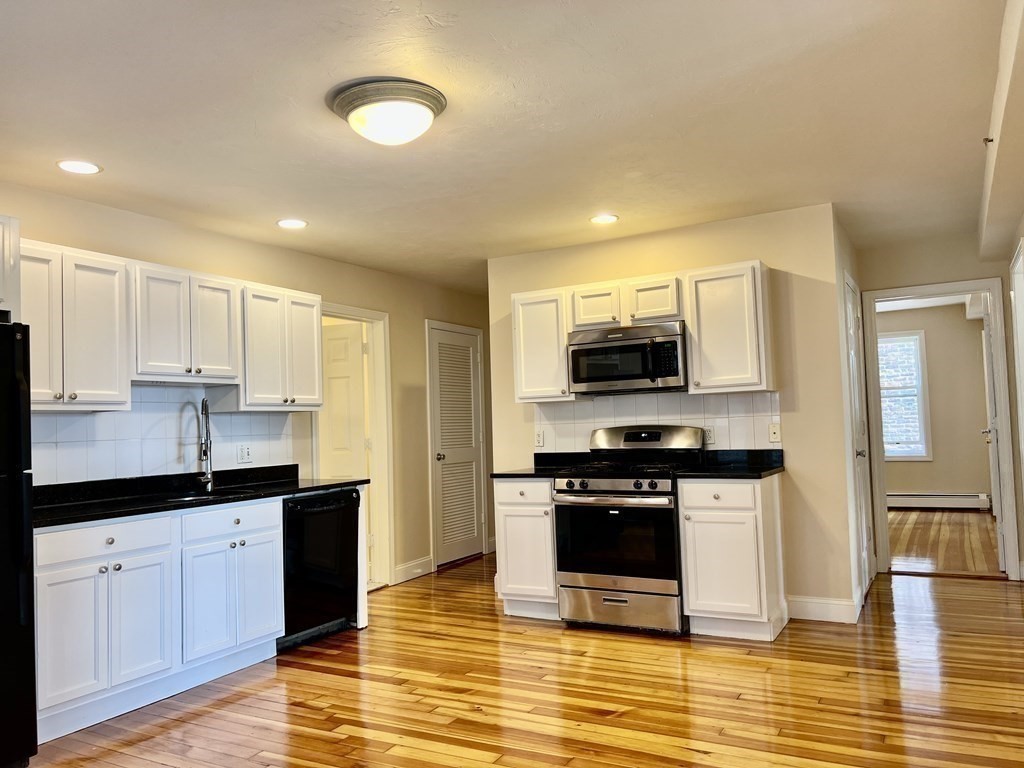 41 Harbor Street, Unit 3 Salem, MA 01970 - Photo 10 of 20 a kitchen with stainless steel appliances granite countertop a stove a sink and a microwave