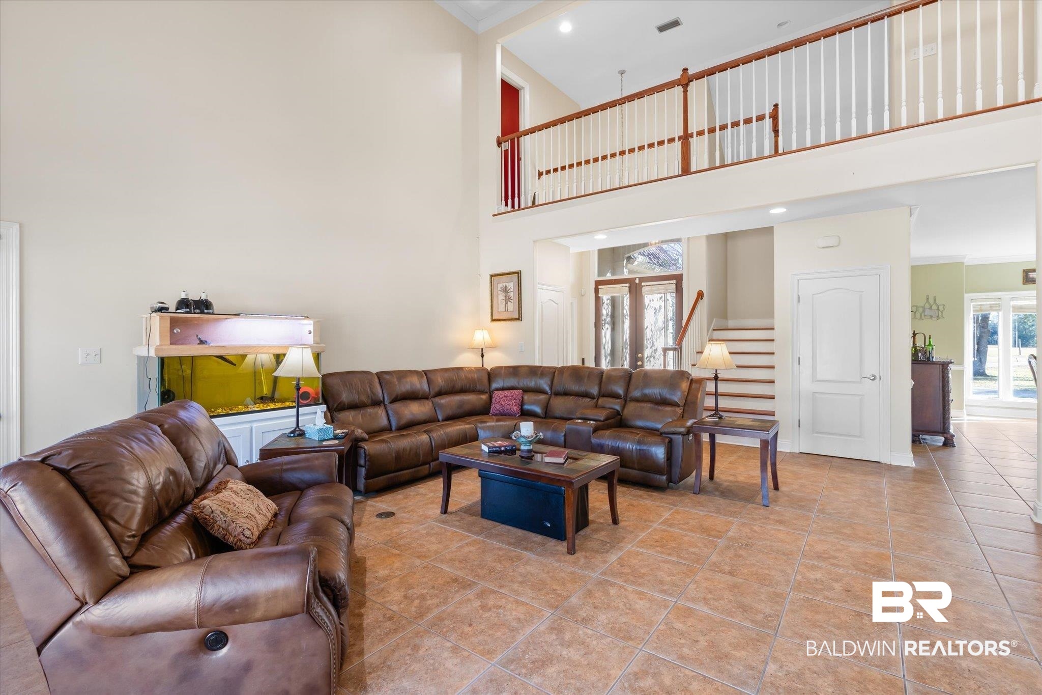 15635 County Road 83 Elberta, AL 36530 - Photo 5 of 54 Living room featuring crown molding, french doors, a towering ceiling, and light tile patterned flooring