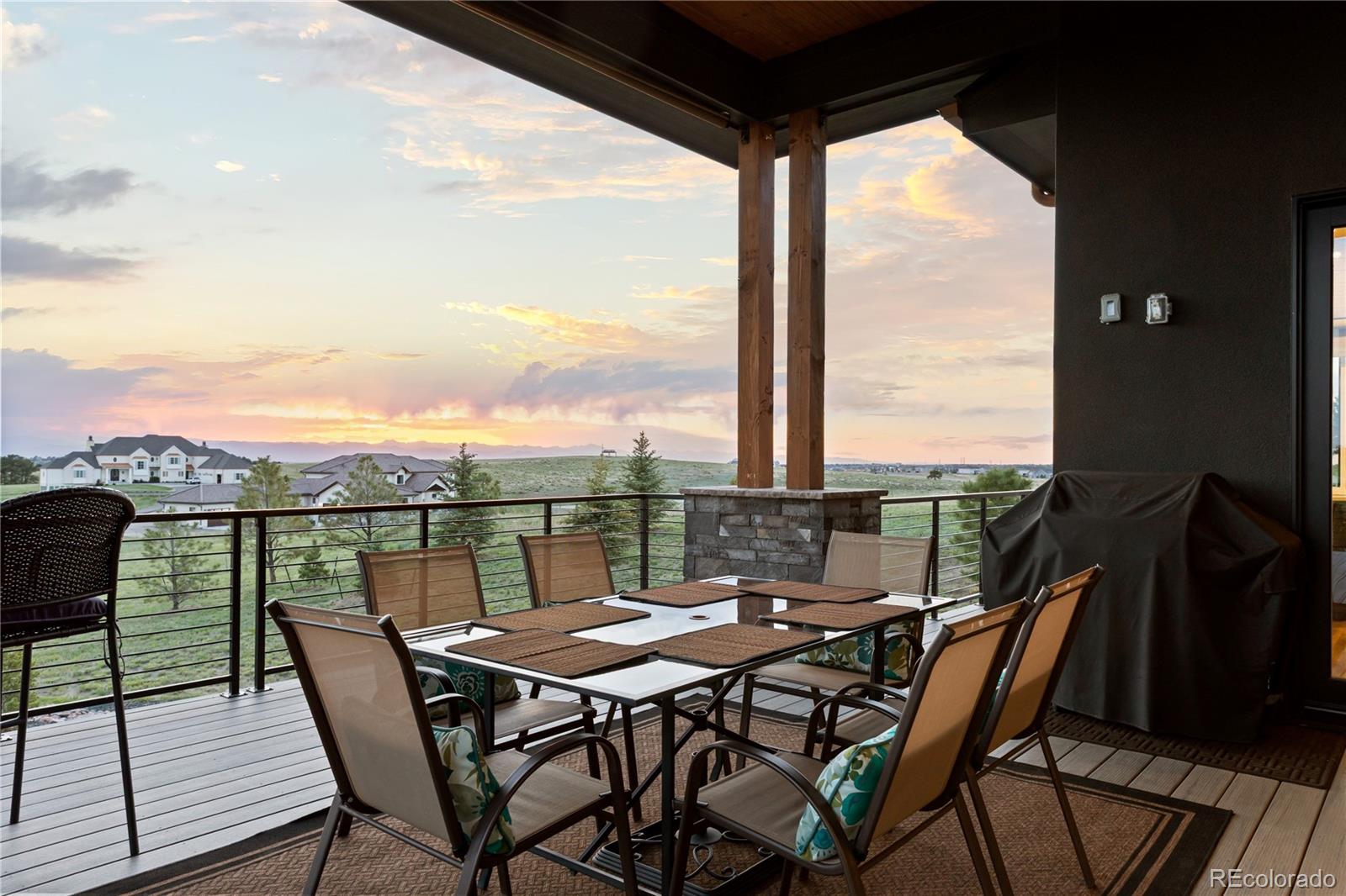 10689 Shadow Pines Road Parker, CO 80138 - Photo 36 of 50 a view of a balcony with table and chairs