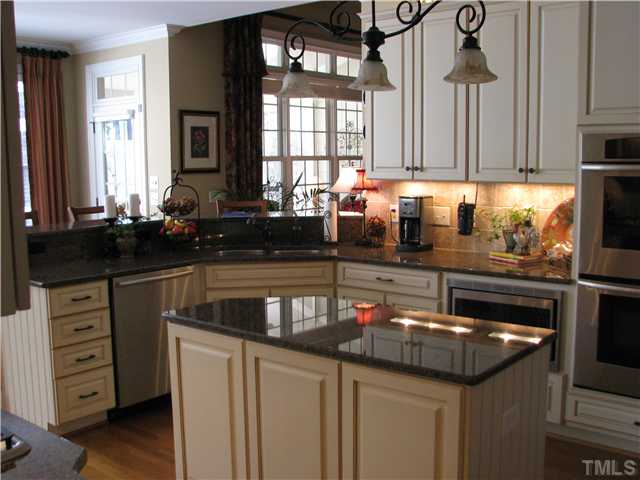 7300 Sparhawk Road Wake Forest, NC 27587 - Photo 3 of 12 CUstom cabinets and top of the line stainless appliances, island and double convention ovens. A gourmet chef's delight!