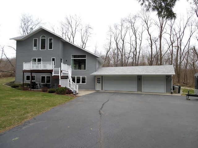 3720 East Flagg Road Ashton, IL 61006 - Photo 1 of 19 a front view of house with yard and trees in the background