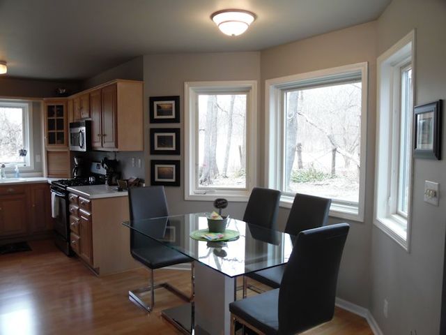 3720 East Flagg Road Ashton, IL 61006 - Photo 4 of 19 a kitchen with a table chairs refrigerator and window