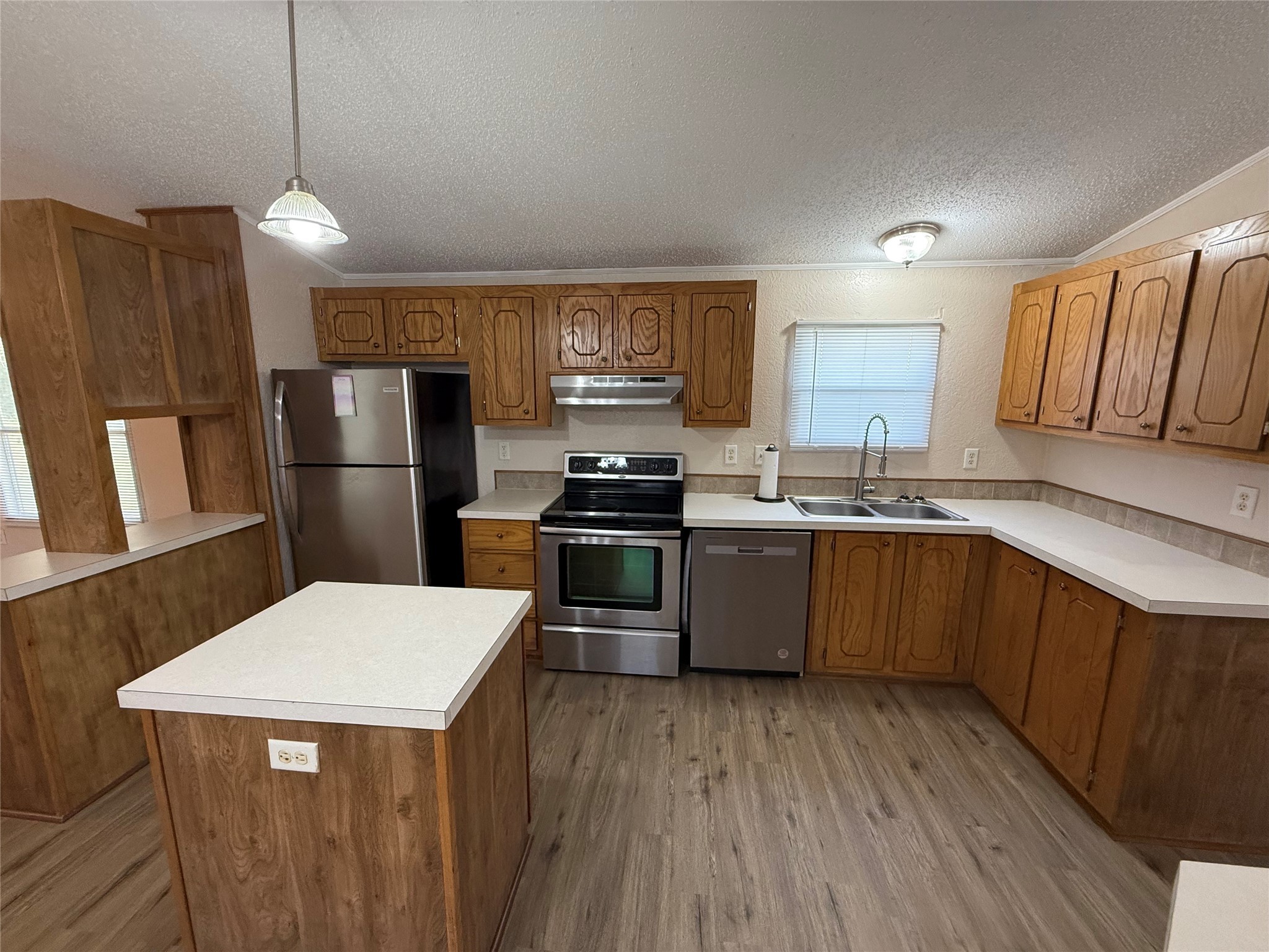 4813 Fm 357 Apple Springs Apple Springs, TX 75926 - Photo 12 of 32 a kitchen with stainless steel appliances kitchen island granite countertop a refrigerator a sink dishwasher a stove with wooden floor and cabinets