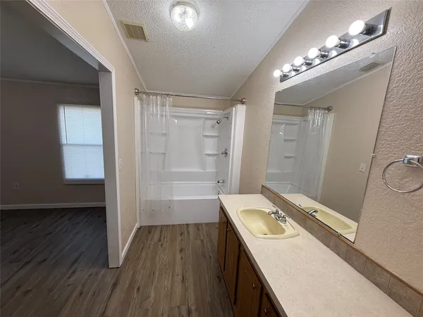 a bathroom with a sink a toilet a mirror and window