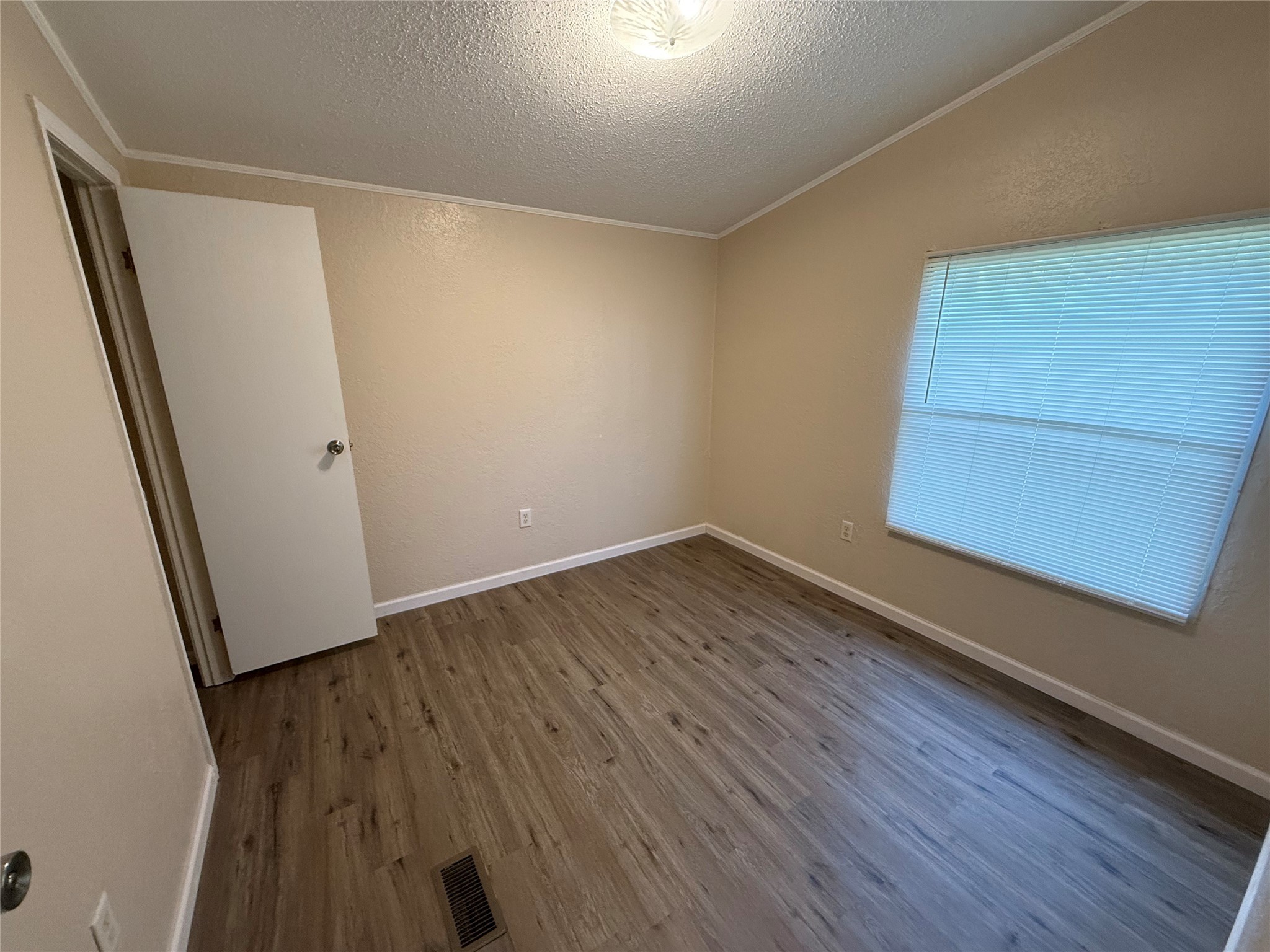 4813 Fm 357 Apple Springs Apple Springs, TX 75926 - Photo 19 of 32 an empty room with wooden floor and entrance