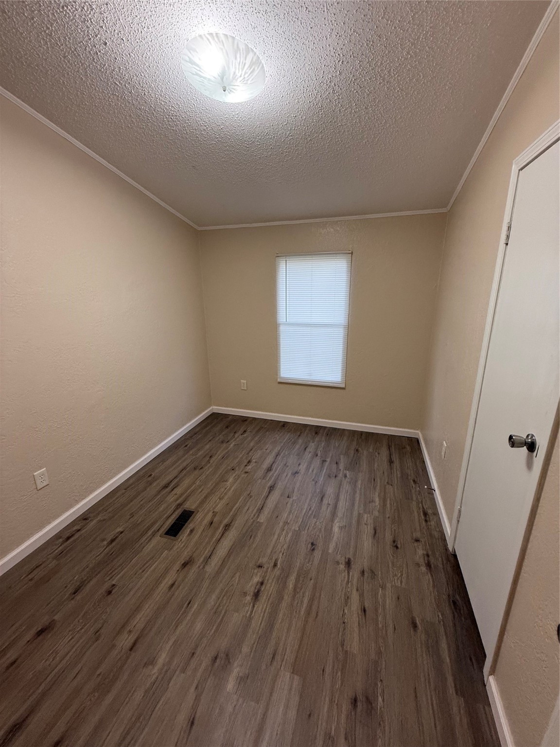 4813 Fm 357 Apple Springs Apple Springs, TX 75926 - Photo 23 of 32 an empty room with wooden floor and windows