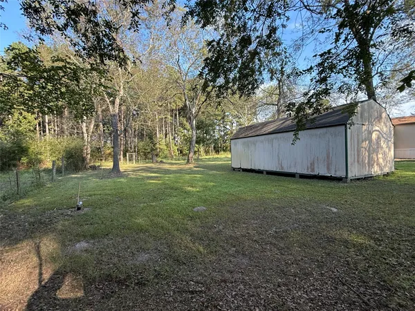 a view of a backyard with large trees