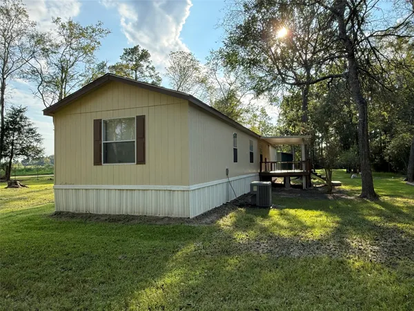 a view of a house with backyard and sitting area