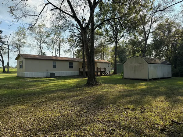 a view of a house with a backyard