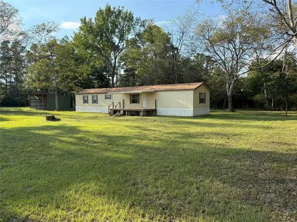 a view of a house with swimming pool and yard