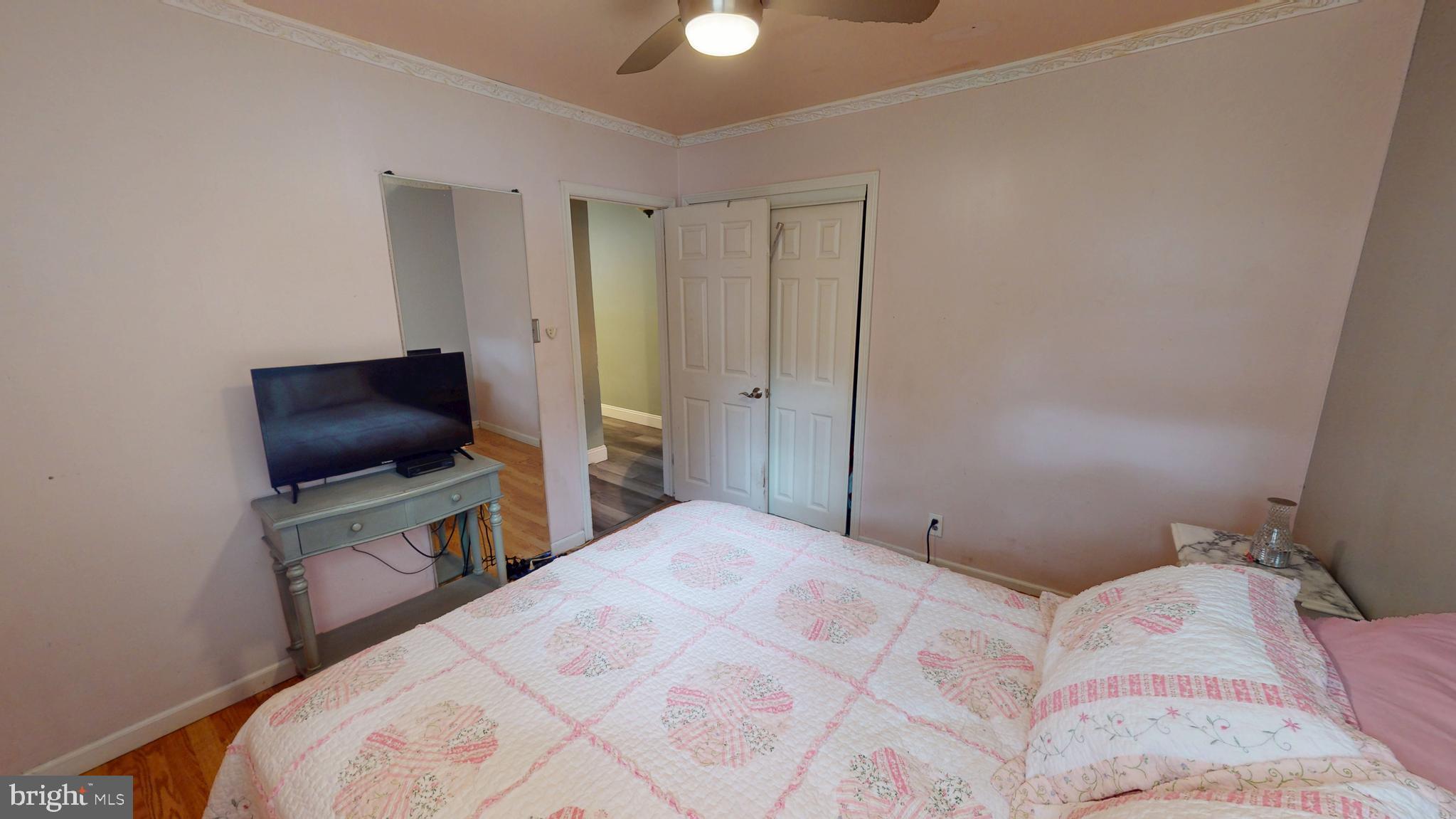 1401 Filbert Street Glassboro, NJ 08028 - Photo 12 of 18 a bedroom with a bed and flat screen tv