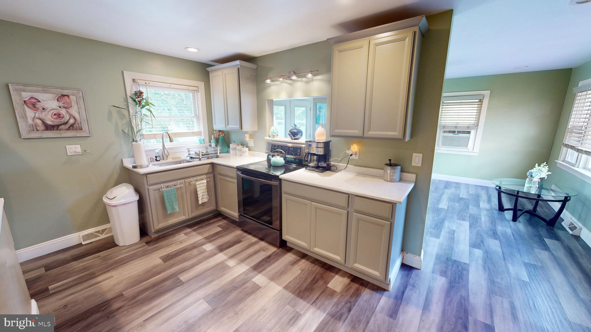 1401 Filbert Street Glassboro, NJ 08028 - Photo 6 of 18 a kitchen with a sink stove and wooden floor