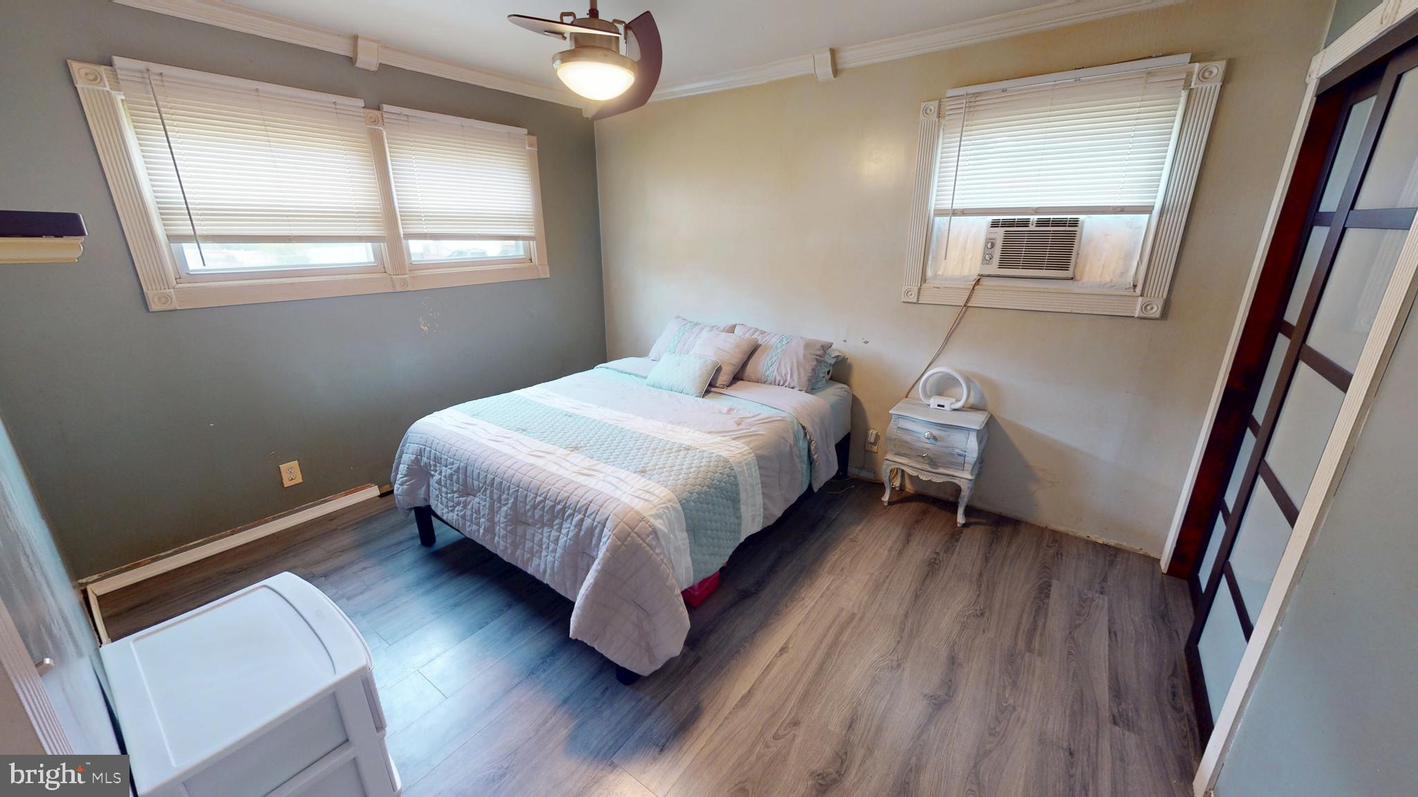 1401 Filbert Street Glassboro, NJ 08028 - Photo 9 of 18 a bedroom with a bed lamp and a mirror