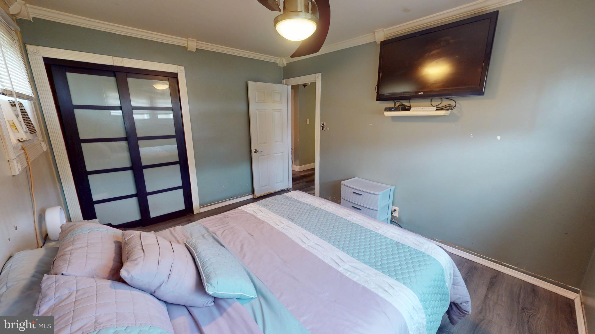 1401 Filbert Street Glassboro, NJ 08028 - Photo 10 of 18 a bedroom with a bed and a flat screen tv