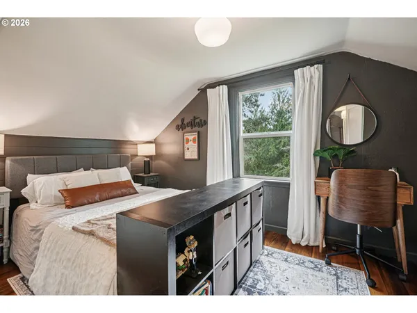 a bedroom with a bed window and chair