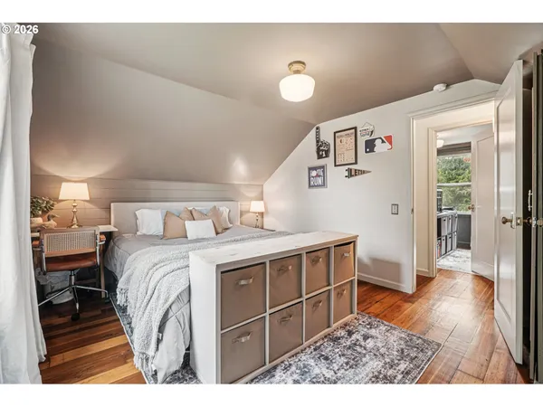 a bedroom with a bed and a view of kitchen