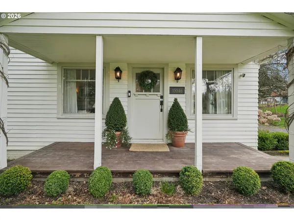 a view of a small house with potted plants