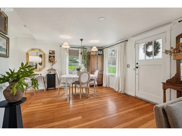 a living room with furniture a chandelier and a dining table