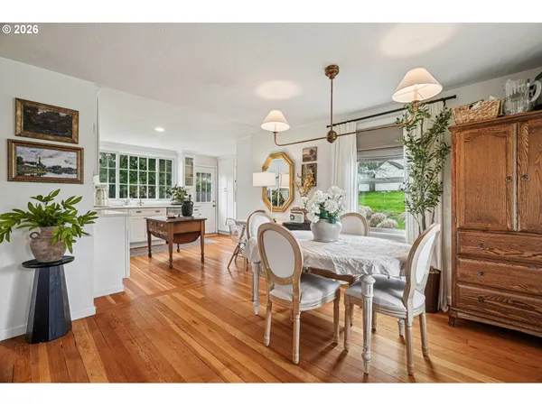 a dining room with furniture and wooden floor