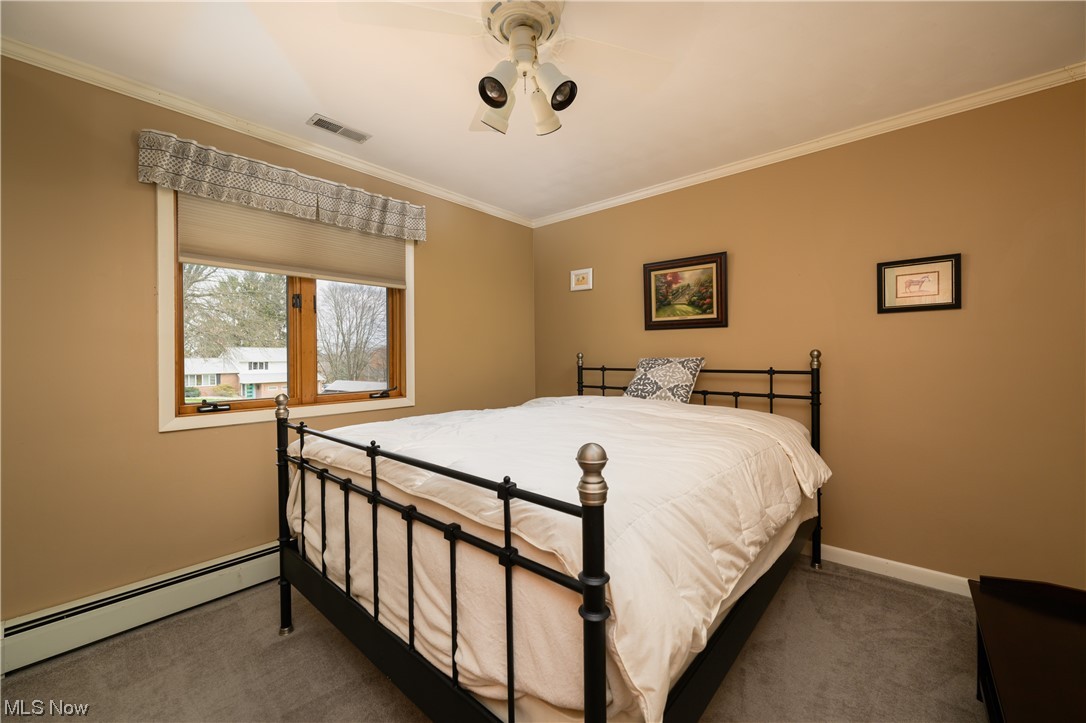5304 Sibila Road Northwest Canton, OH 44718 - Photo 24 of 29 Carpeted bedroom featuring ceiling fan, baseboard heating, and ornamental molding