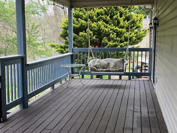 a view of balcony with wooden floor and outdoor seating