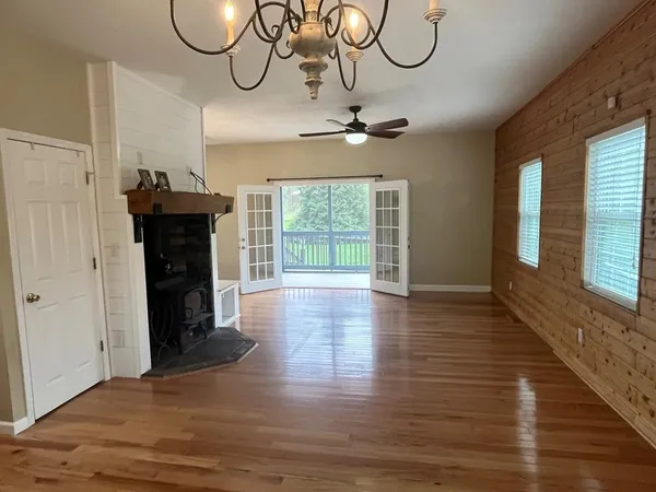 a view of a room with wooden floor and windows