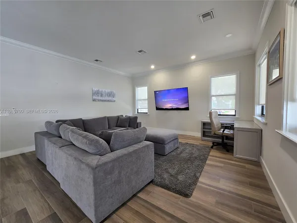 a living room with furniture wooden floor and a rug